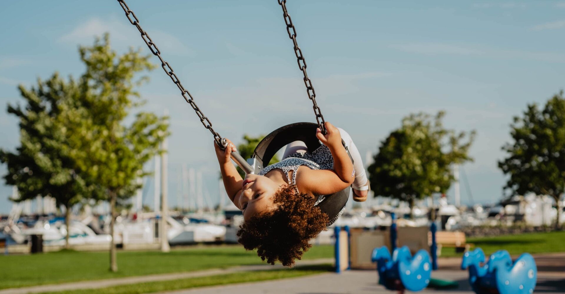 Little girl having fun on swing